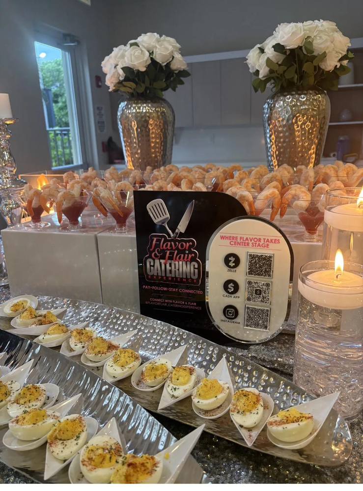 Flavor and Flair Catering appetizer display with deviled eggs, shrimp cocktail, and QR codes