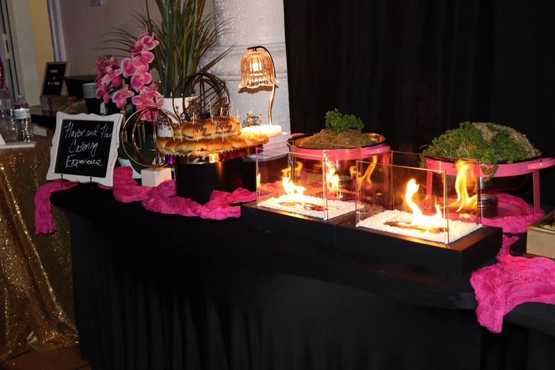 Flavor and Flair Catering birthday event setup with tabletop fire pits and slider display