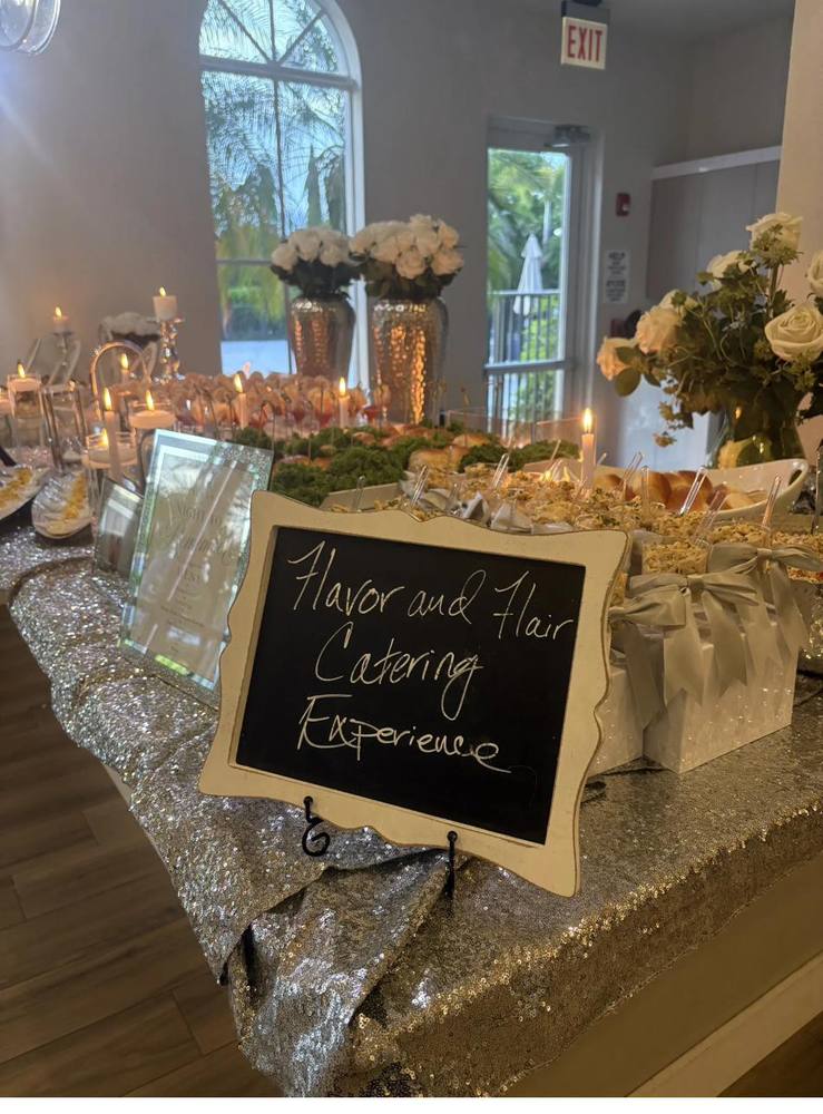Flavor and Flair Catering event spread with silver sequin tablecloth and white roses