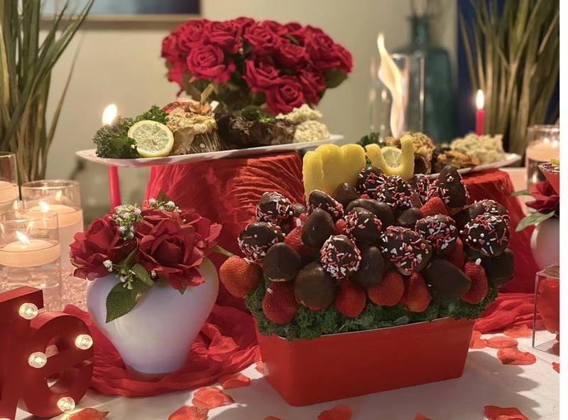 Flavor and Flair Catering private dining with chocolate-covered strawberries and red rose centerpiece