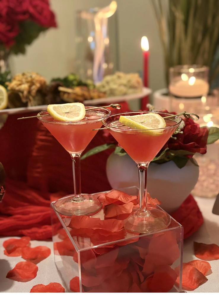 Flavor and Flair Catering private dinner cocktails with lemon garnish on pedestal display